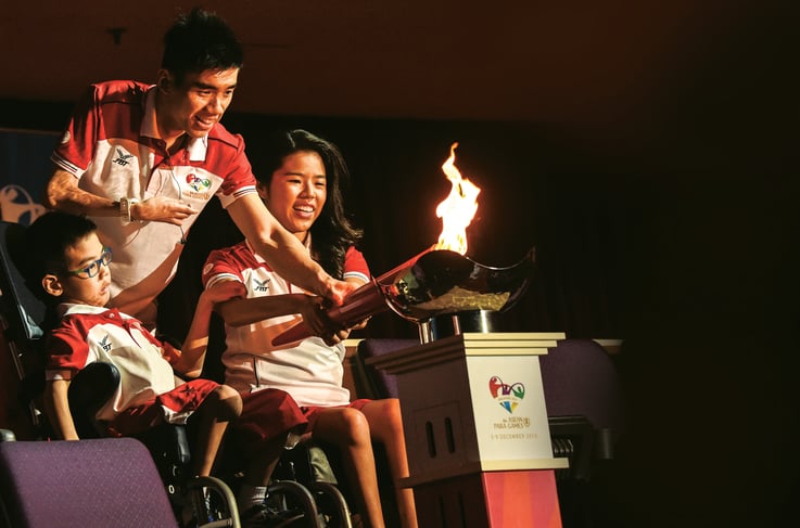 Photo of para three athletes lighting up the ASEAN Para Games cauldron